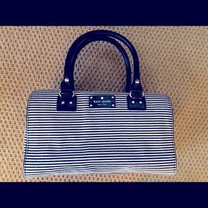 Fun Kate Spade black/beige striped Satchel.  Two comfy handles, 4 brass “feet”.